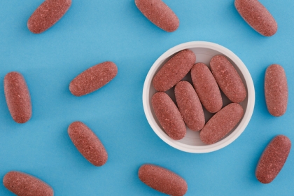 Red yeast rice tablets on a blue background