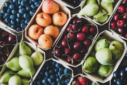 Seasonal produce - Flat-lay of ripe strawberries, cherries, grapes, blueberries, pears, apricots, figs in wooden eco-friendly boxes