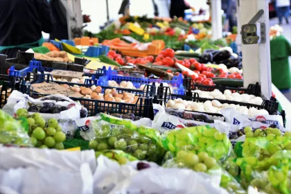 Green grapes and other produce on display at an outdoor market