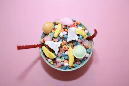 A bowl of colorful cereal, candies, and multi-colored marshmallows 