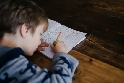 A boy focused on homework.