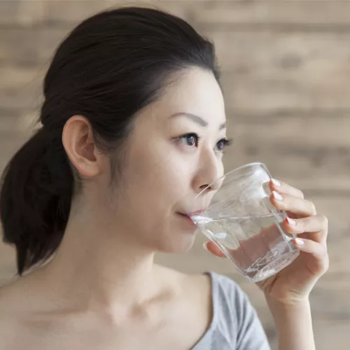 woman drinking a glass of water