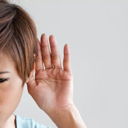 woman with hand to her ear