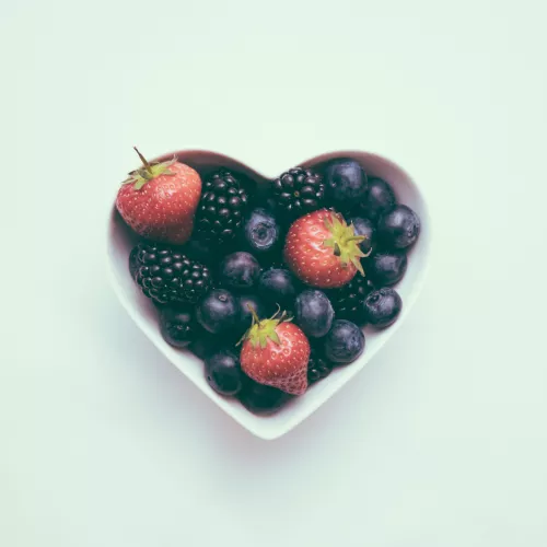 Heart shaped bowl with blueberries and strawberries