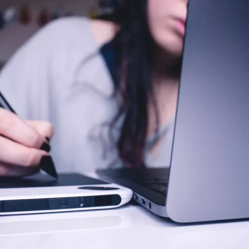 Woman writing something on a tablet