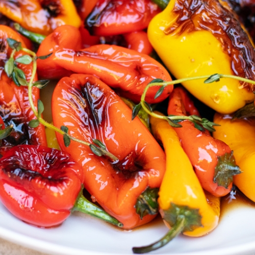 bowl of grilled red, yellow and orange mini bell pepers