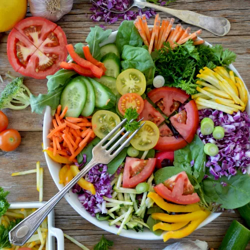 A colorful healthy salad in a wide bowl on a table