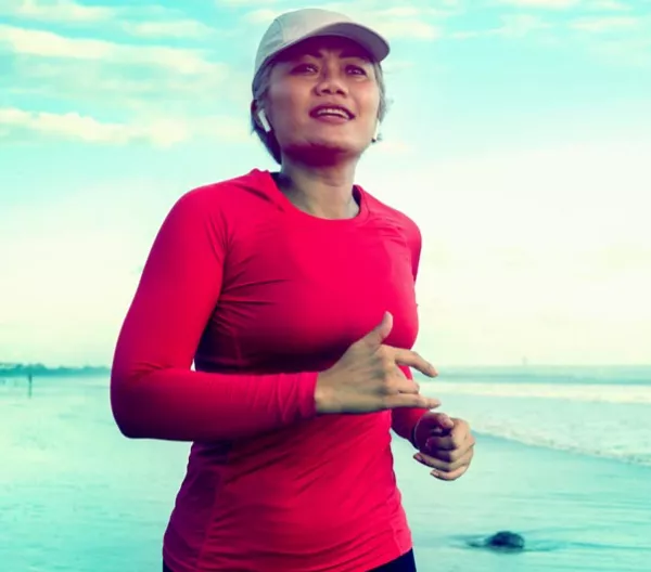 a woman jogging on the beach