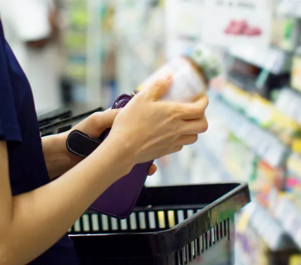 person looking at a vitamin bottle in a store