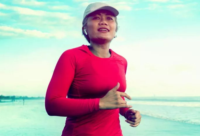 a woman jogging on the beach