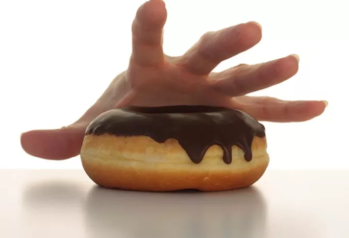 hand reaching for a donut