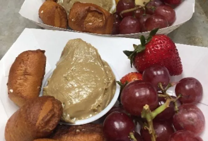 A breakfast tray: pretzel bites and sunbutter, berries, and grapes.