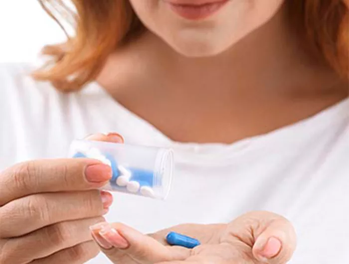 woman holding pill bottle