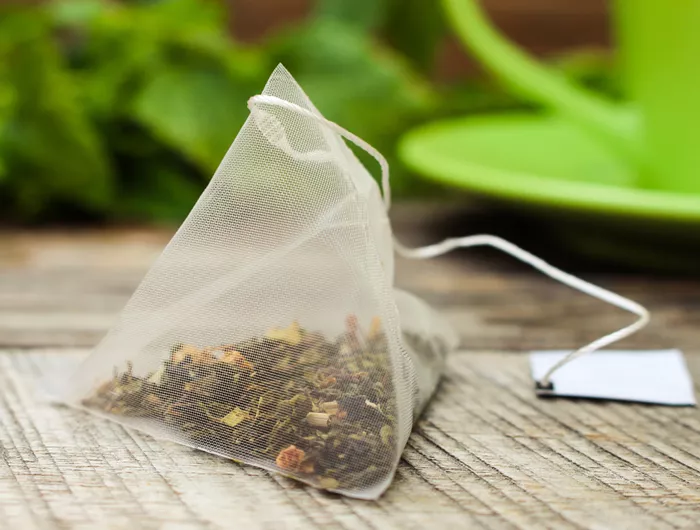 tea leaves in a plastic pyramid-shaped tea bag