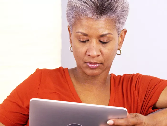 a woman reading news on her tablet