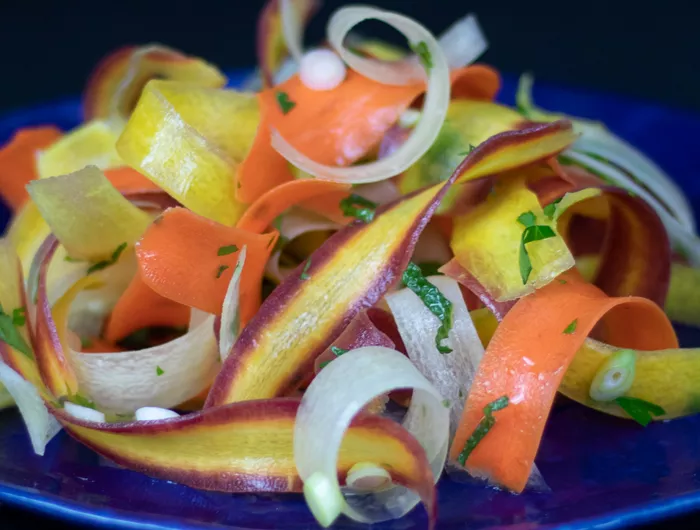 shaved carrots topped with herbs