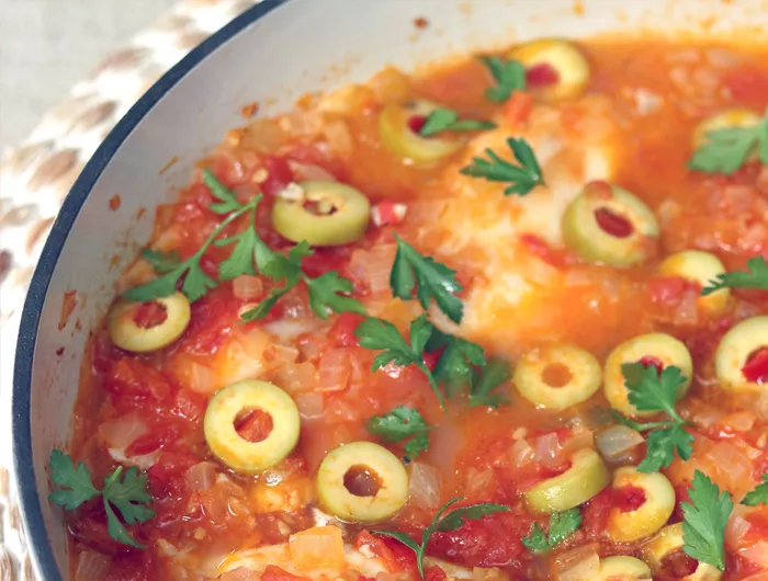 fish submerged in tomato based sauce