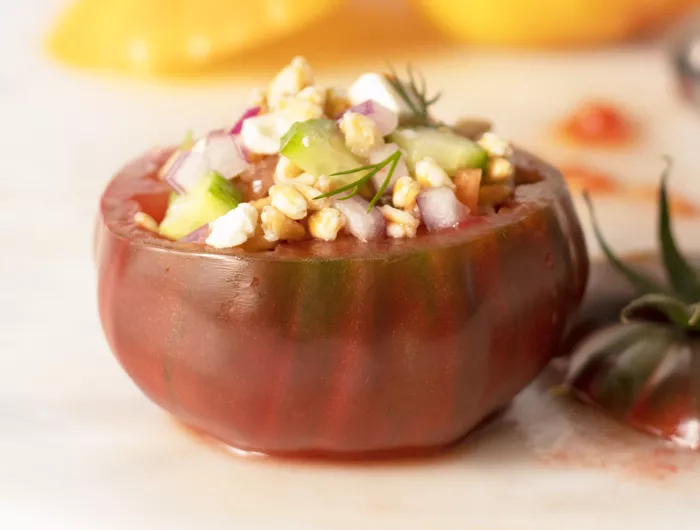 a greek farro stuffed tomato