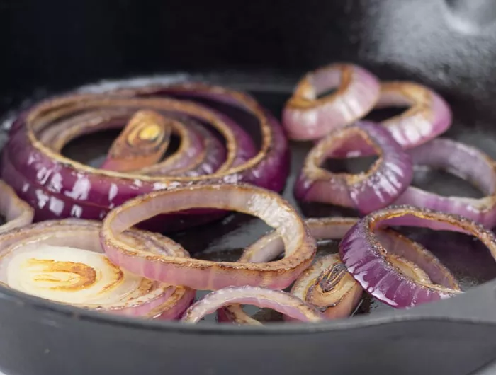 a skillet of sautéed red onion