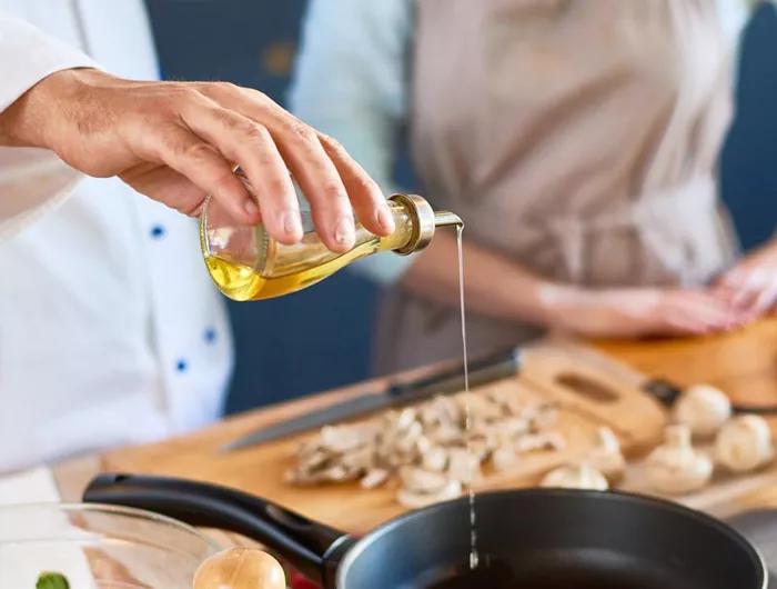 pouring oil into a skillet