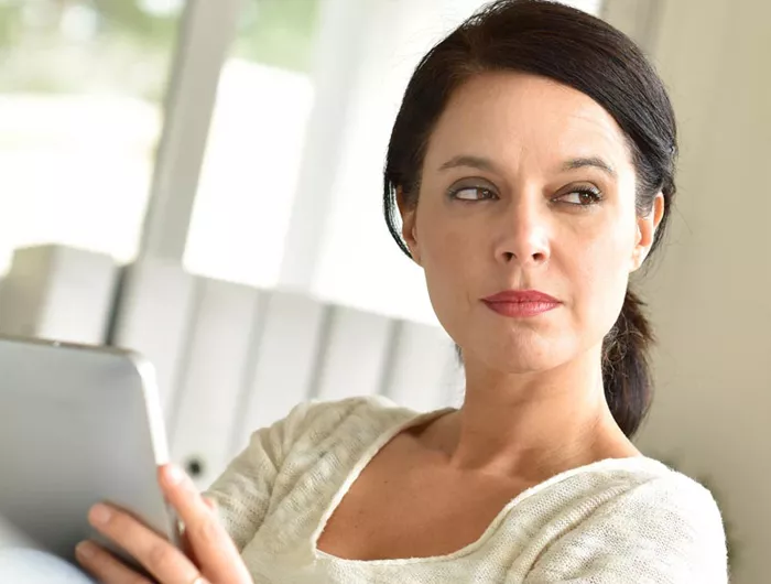 woman holding a tablet screen