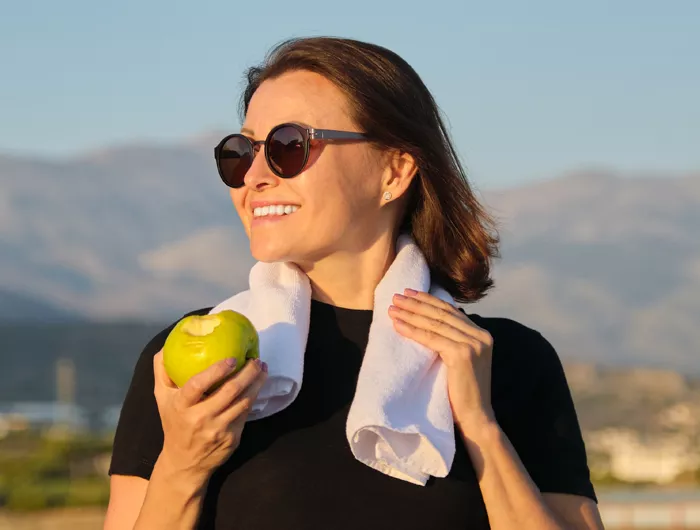 a woman holding an apple