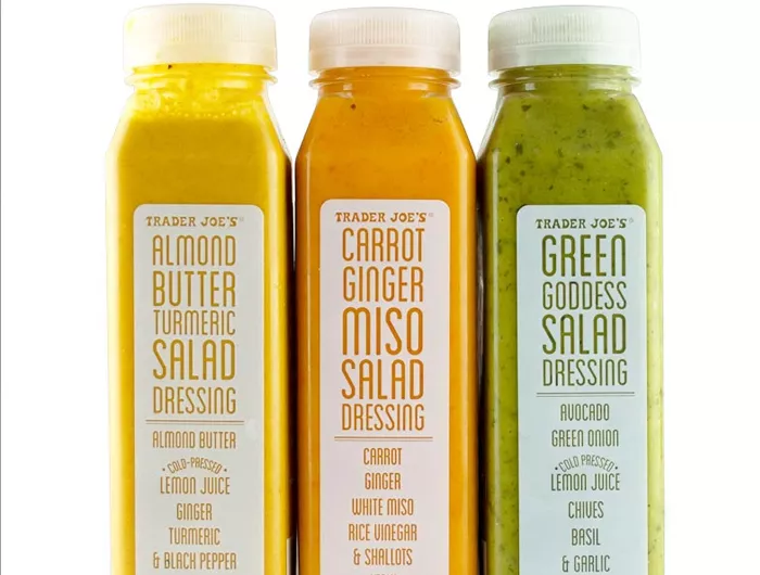 three bottles of trader joe's refrigerated salad dressing.