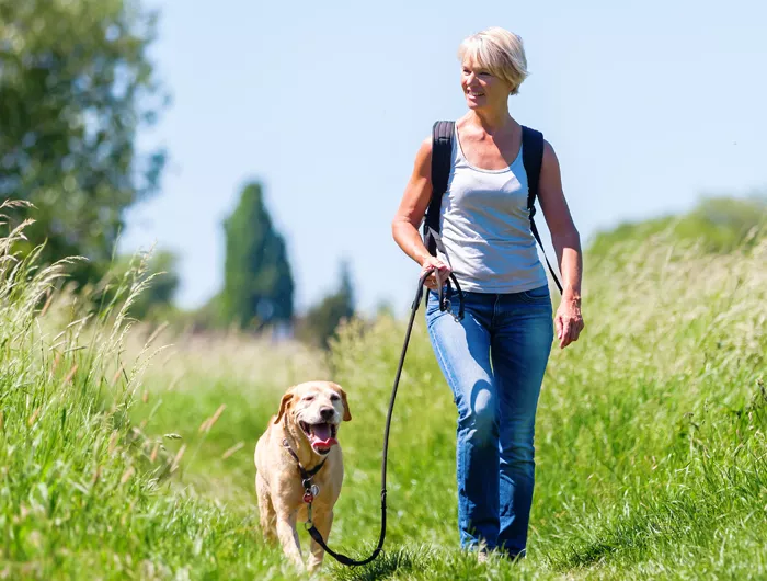 a woman walking her dog