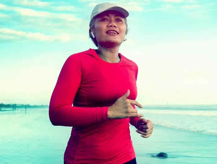 a woman jogging on the beach