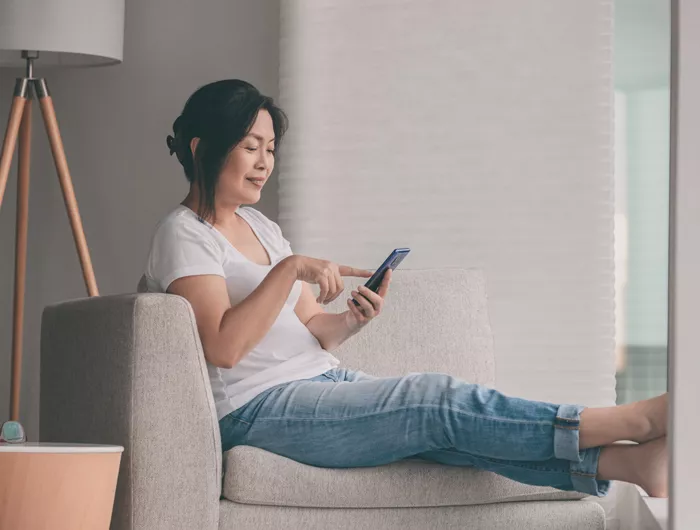 a woman sitting and using her cellphone