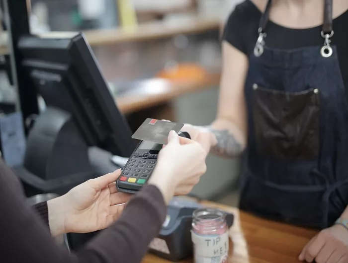 Worker holding credit card