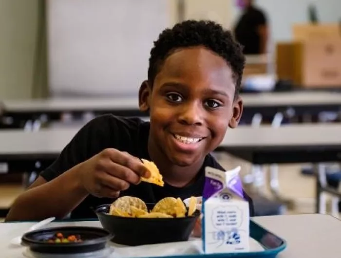 A boy eating school lunch