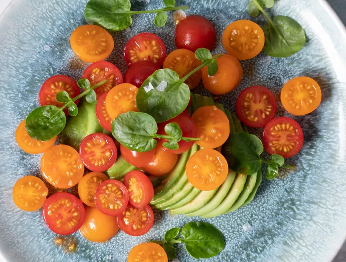 tomatoes and sliced avocado on plate