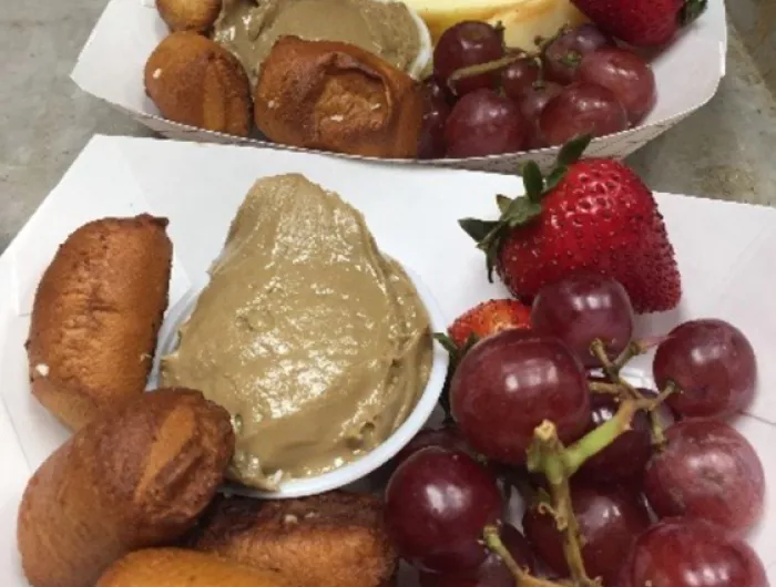 A breakfast tray: pretzel bites and sunbutter, berries, and grapes.