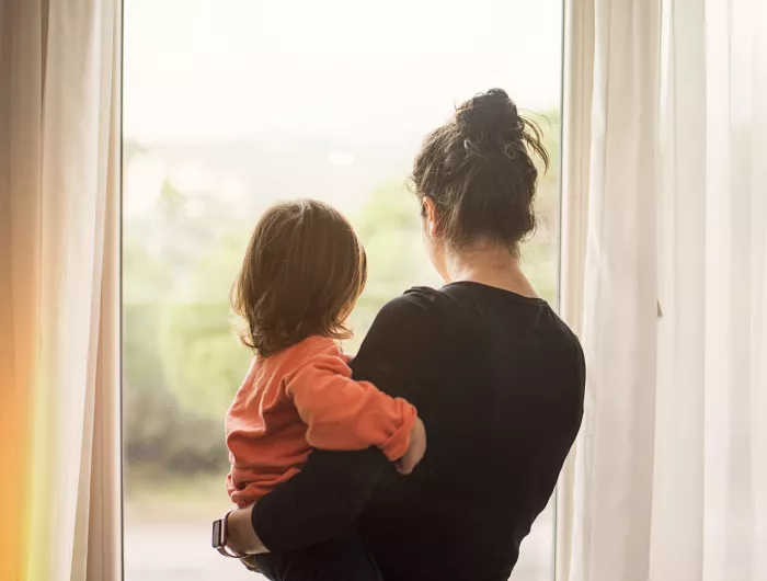 Mother and child looking out of window