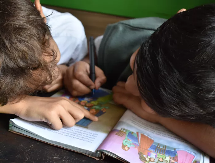 Two young classmates doing schoolwork