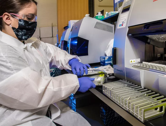 A CDC scientist unpacking testing kits