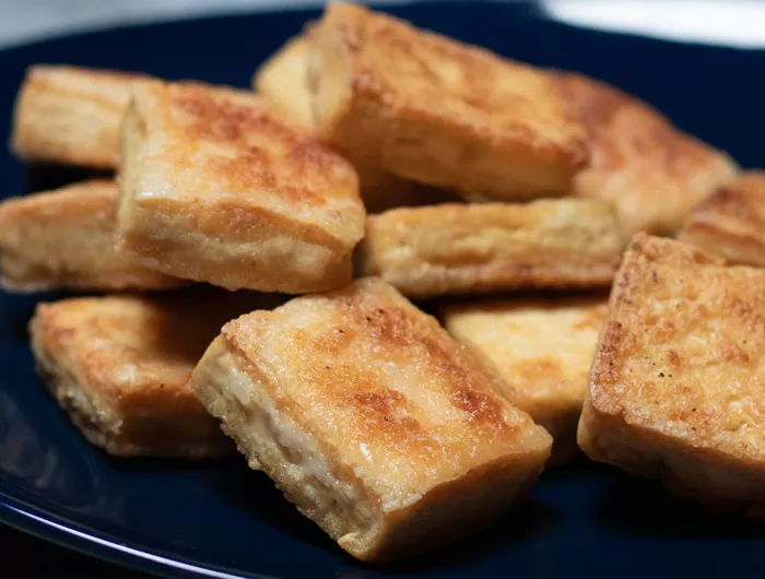 black pan with crispy tofu pieces 