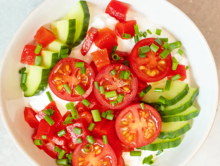 bowl filled with tomatoes, cucumbers and cottage cheese