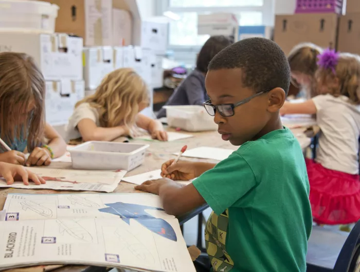 A group of young students focusing on their work.