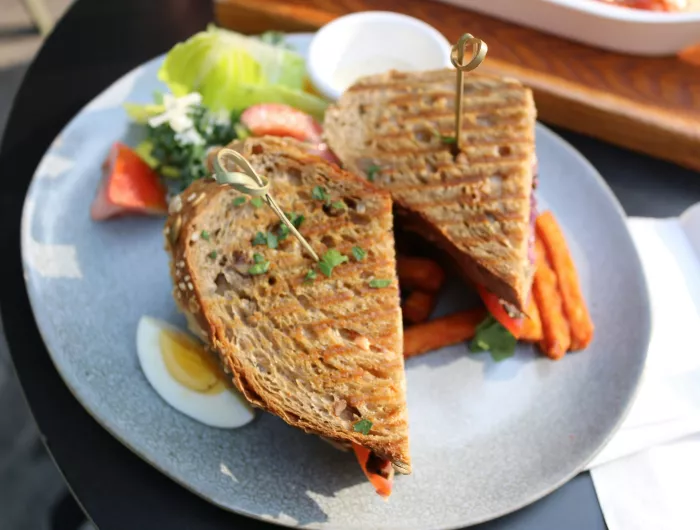 Sandwich with carrot sticks and a side salad