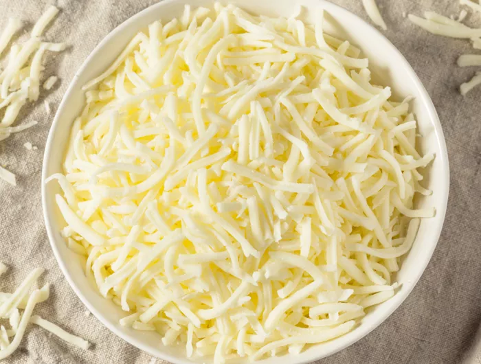 white bowl filled with light shredded cheese