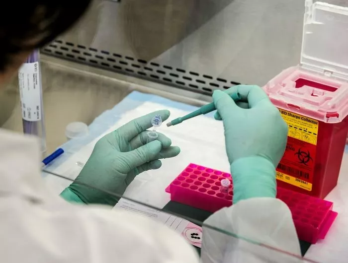 CDC scientist prepares biopsy sample for molecular testing in laboratory