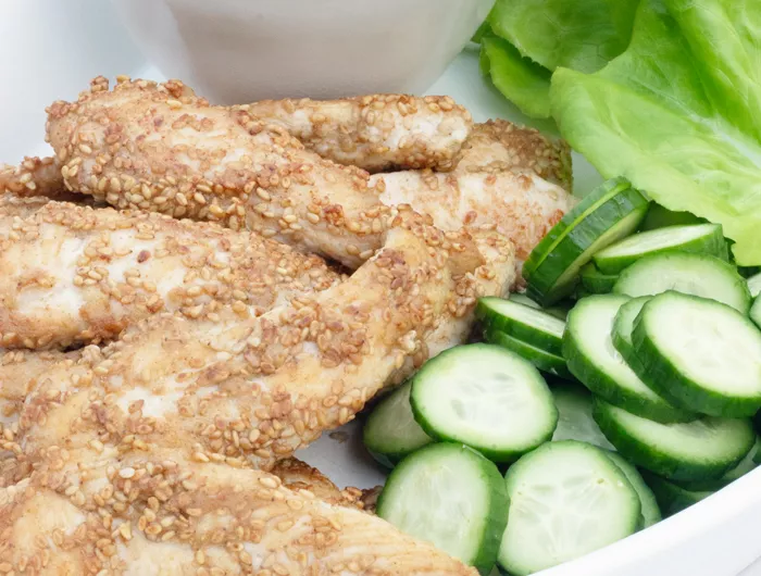 plate with lettuce cucumber and sesame chicken