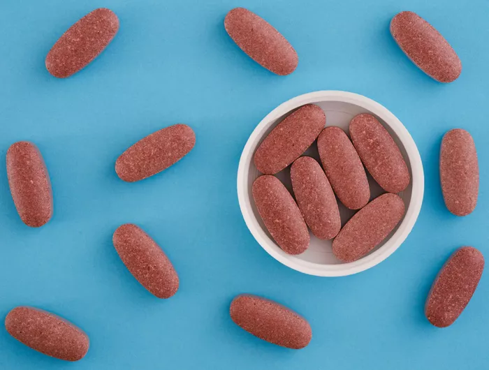 Red yeast rice tablets on a blue background