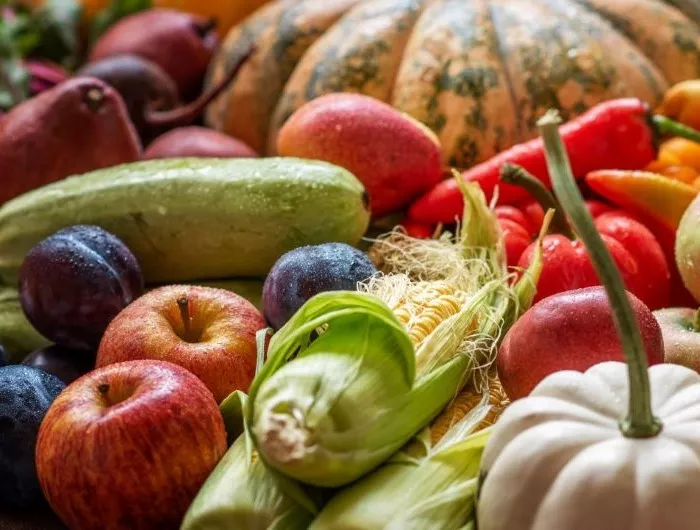 Seasonal produce - a variety of September produce, including apples, peppers, pumpkins, corn, and zucchini