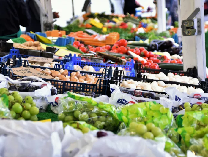 Green grapes and other produce on display at an outdoor market