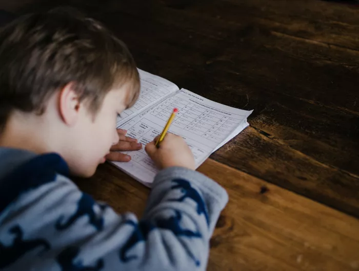 A boy focused on homework.