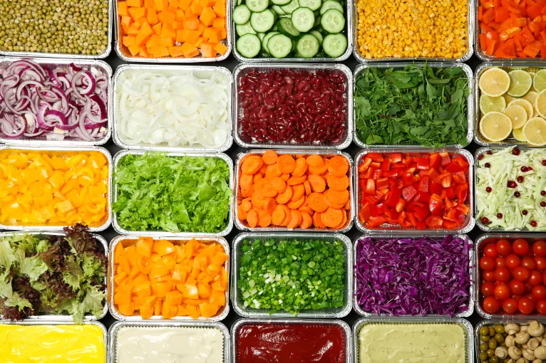 A healthy salad bar full of bright fruits and vegetables