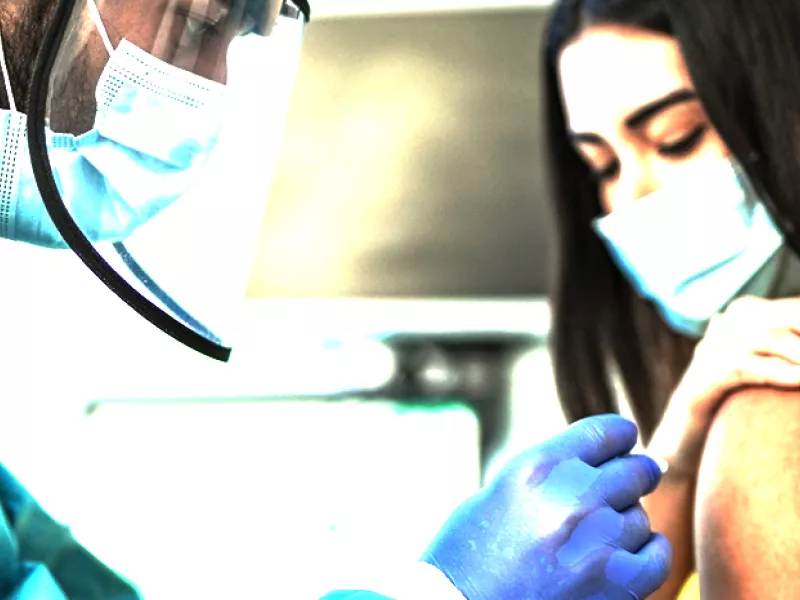 young woman getting a vaccination shot